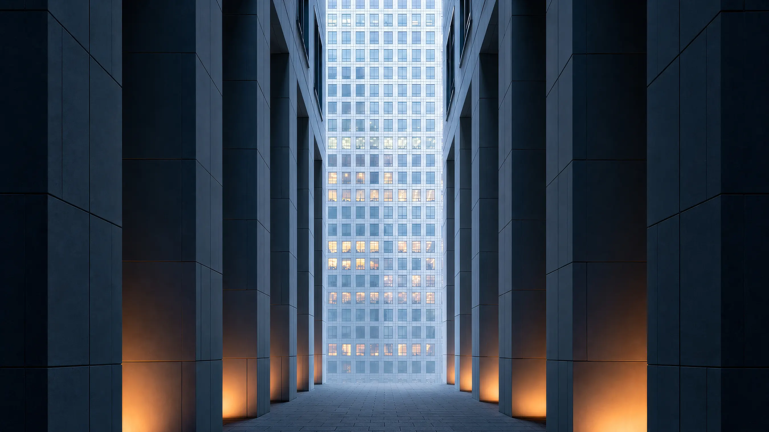 A colonnade framing a clear line of sight towards a tower